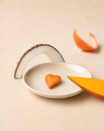 Coconut on Mango botanical tea melt on a ceramic plate with mango and coconut